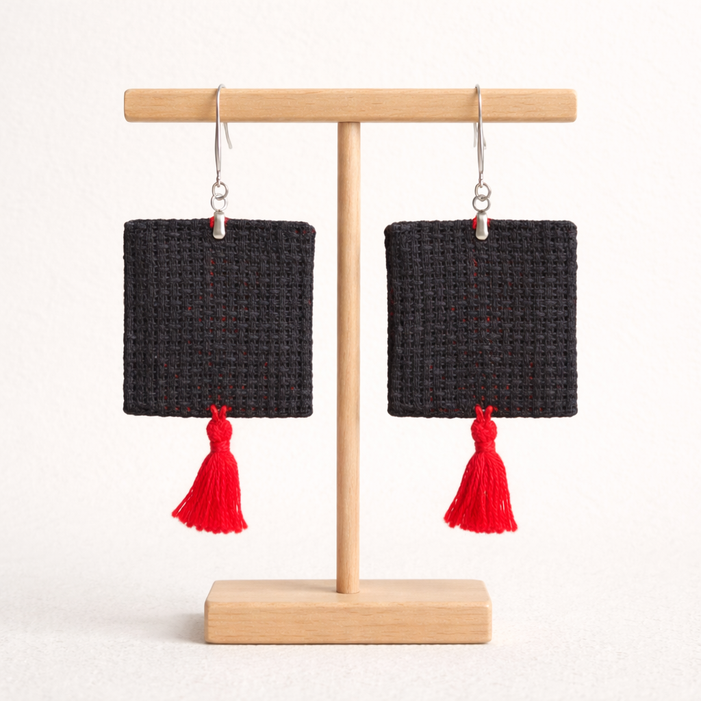 Back view of Ramallah thobe panel inspired Palestinian Tatreez embroidered earrings on wooden stand
