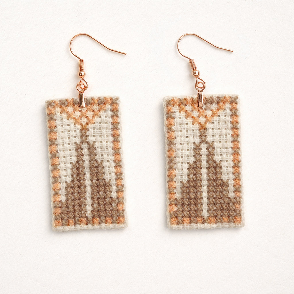 Pair of Sarwa cypress tree Ashdod tatreez earrings showing geometric Palestinian cross stitch design