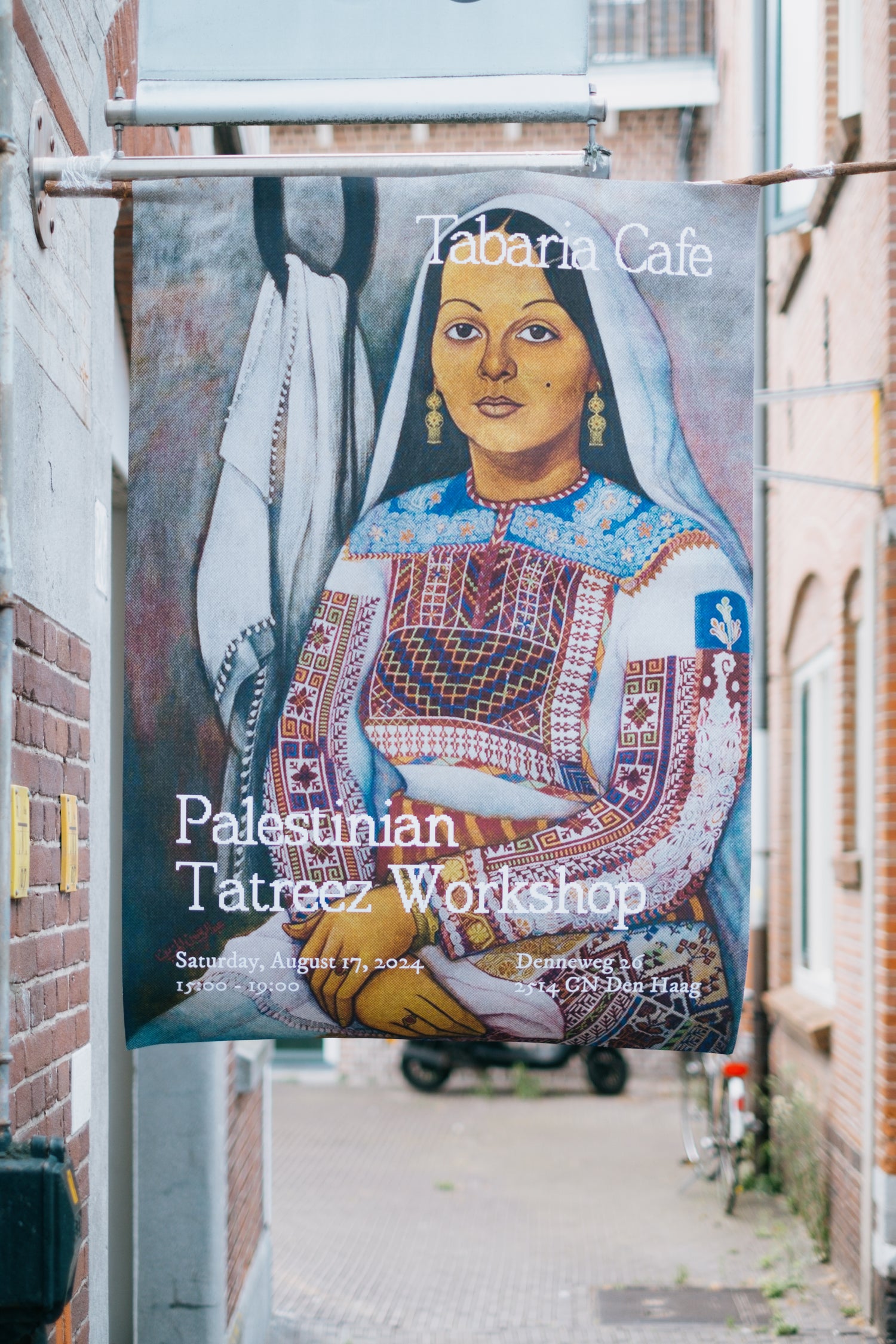Poster for the Tatreez workshop displayed at Tabaria Cafe, advertising the upcoming event on January 16, 2024.