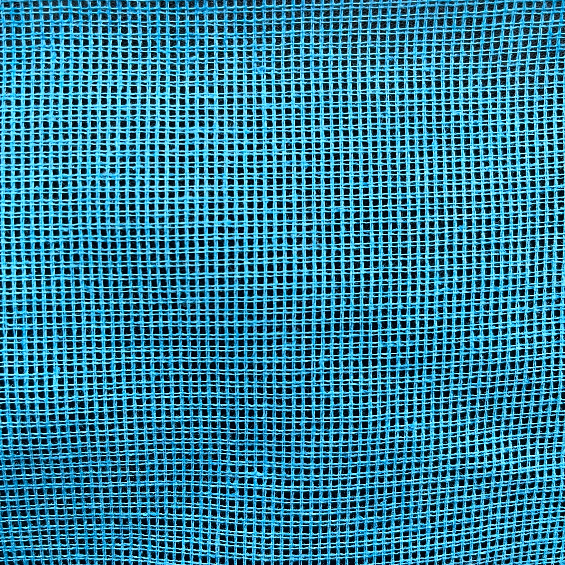 Close-up of blue 12ct waste canvas grid for embroidery stitching