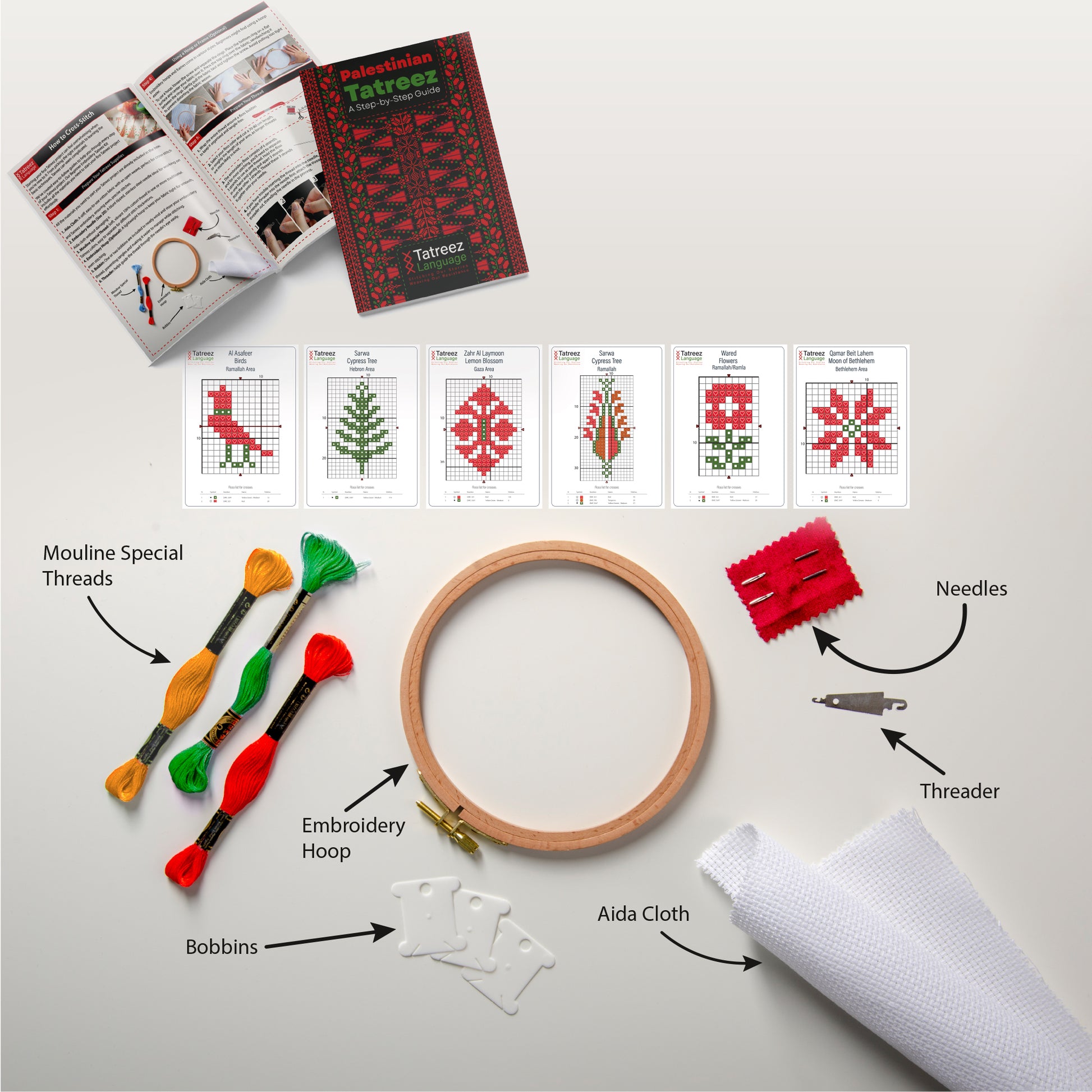 A detailed view of the Tatreez Learning Kit contents, including embroidery threads, Aida fabric, a wooden hoop, a needle, and a guide booklet spread over a white background.