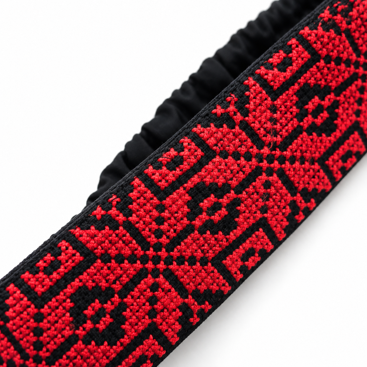 Close-up detail of Palestinian Tatreez embroidery featuring the Star of Bethlehem (Nijmat Beit Lahem) on a handmade hair band