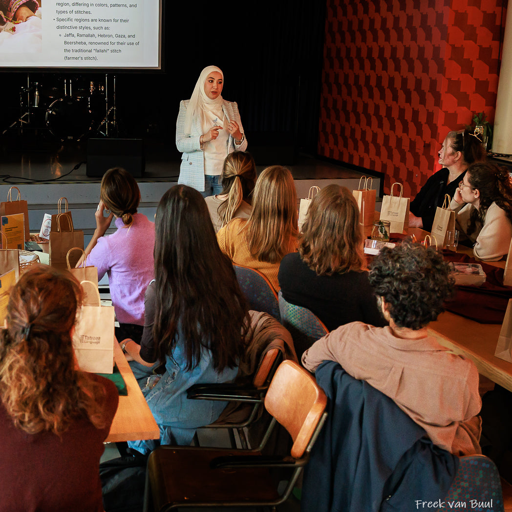 Instructor demonstrating traditional Palestinian tatreez embroidery during a hands-on workshop at CKE Eindhoven.