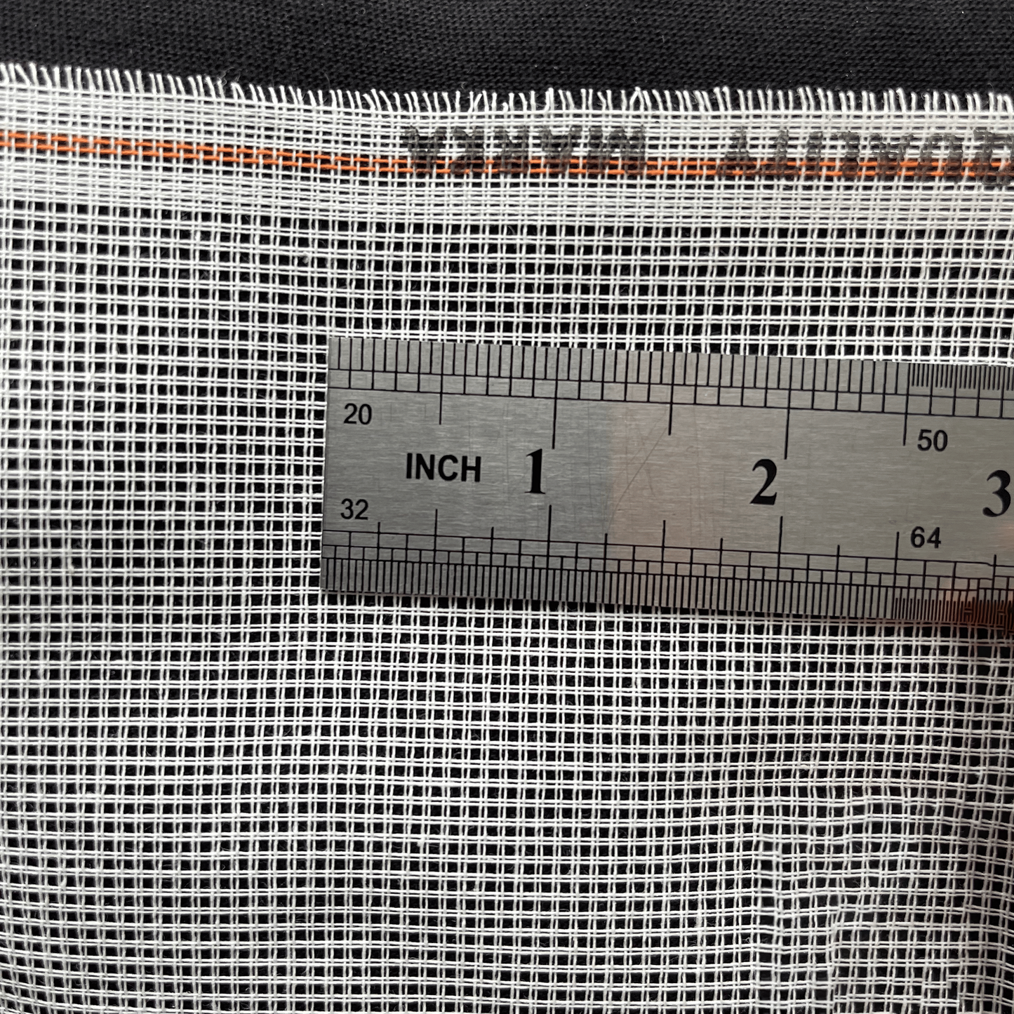 White 11ct waste canvas with ruler showing stitch spacing and grid size