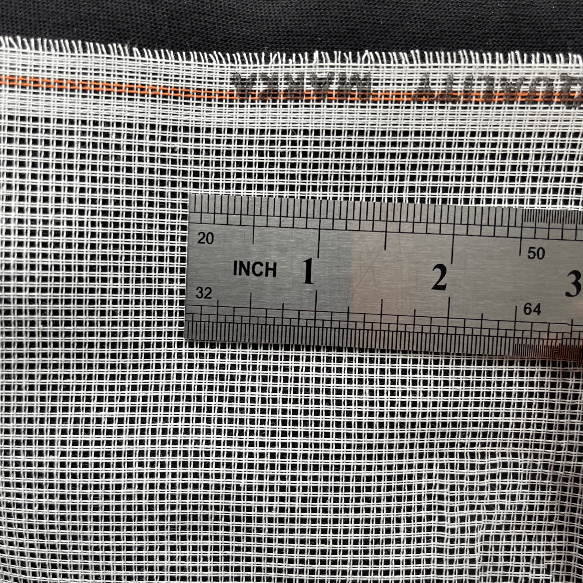 White 11ct waste canvas with ruler showing stitch spacing and grid size