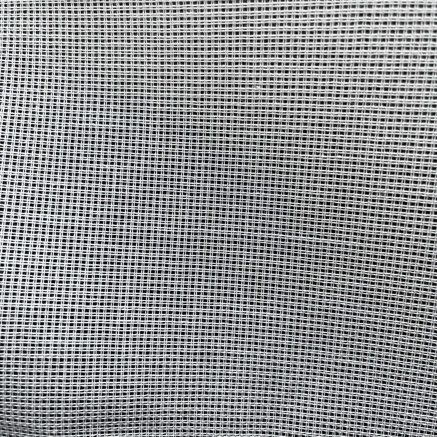 Close-up of white 14ct waste canvas grid for embroidery stitching