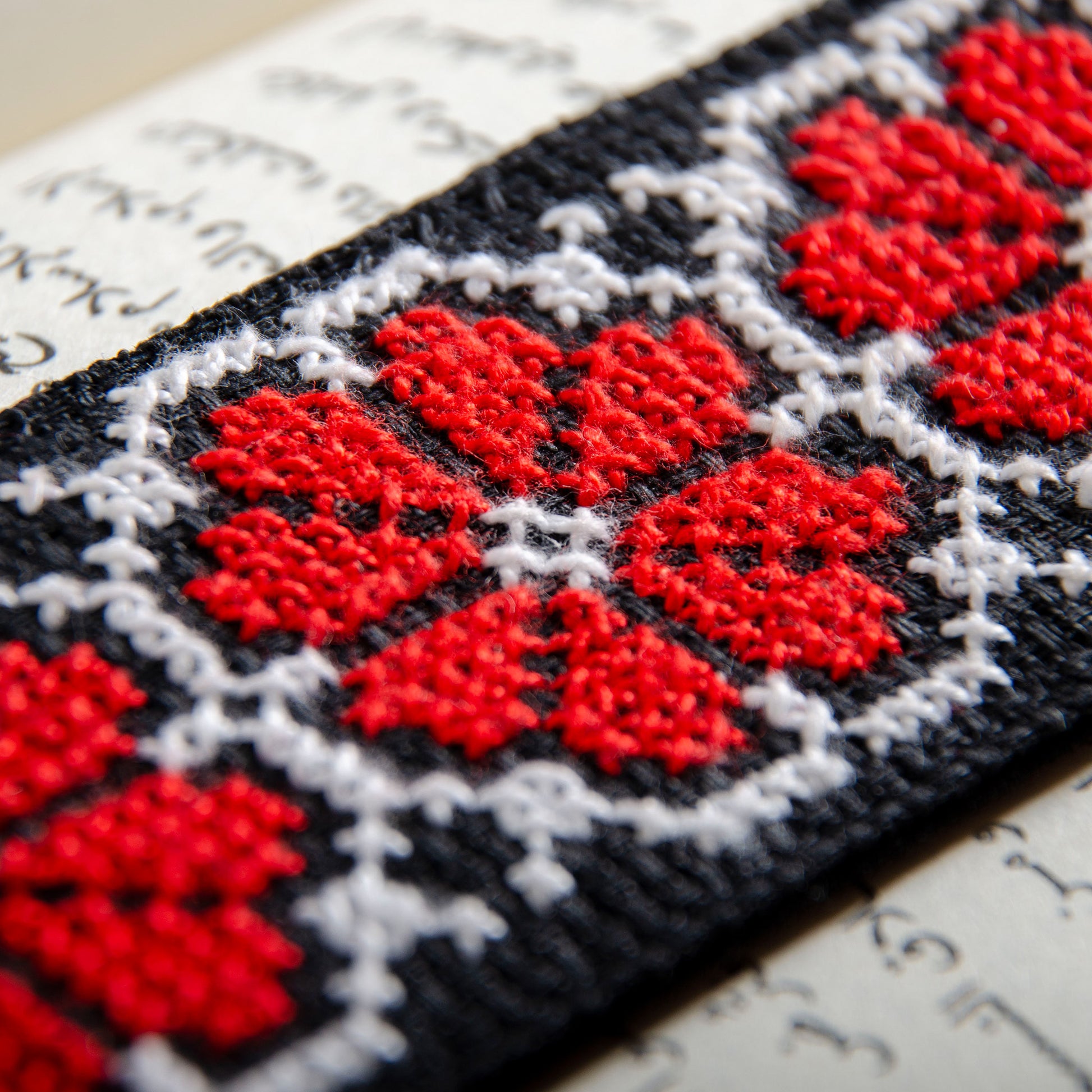 Close-up detail of Damascus Roses Palestinian tatreez embroidery on handmade bookmark