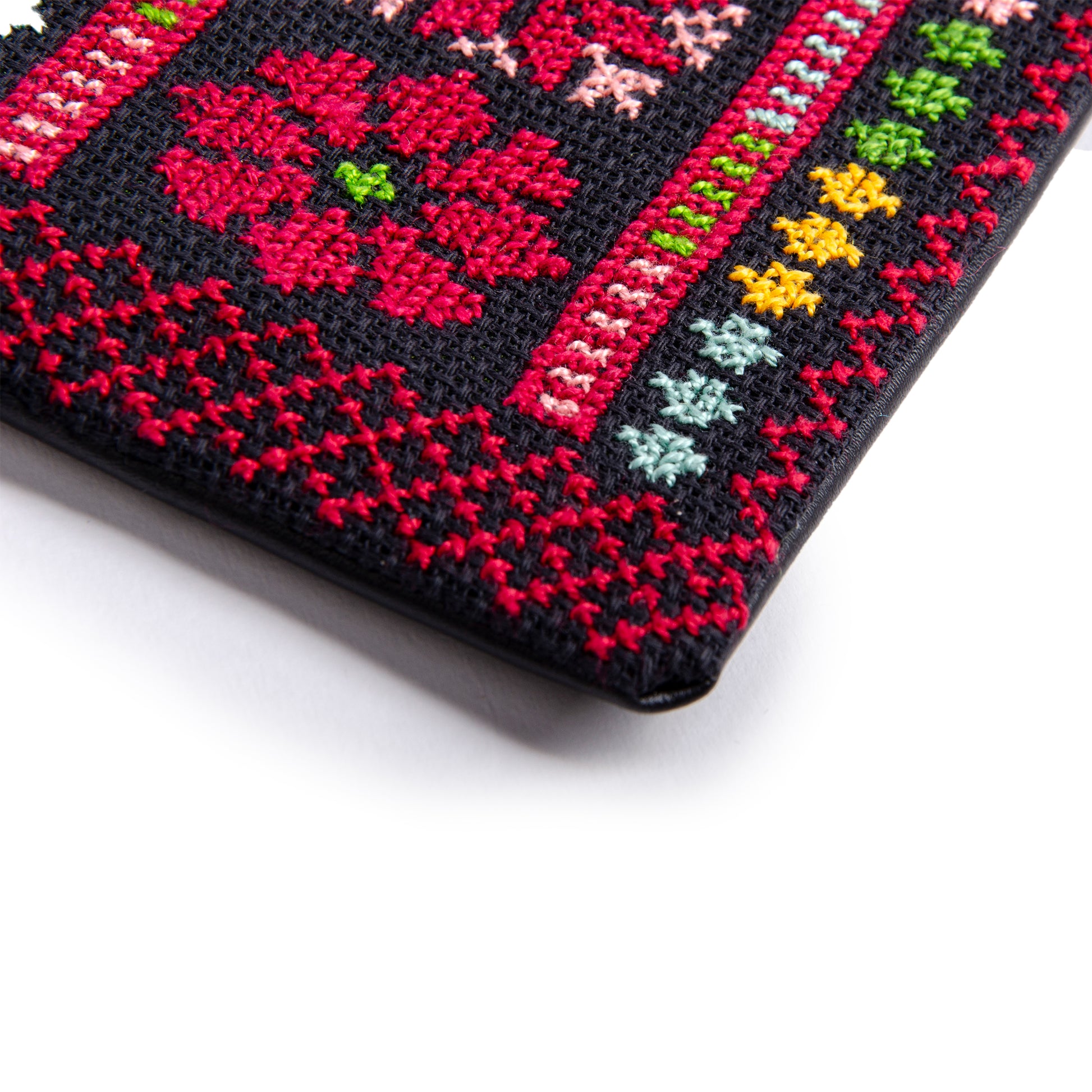 Close-up of handmade Palestinian embroidered purse with traditional Tatreez floral motif, size 15x10 cm.