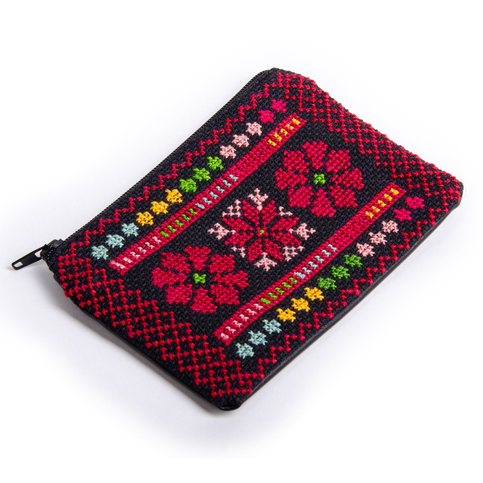 Handmade Palestinian embroidered purse featuring floral Tatreez design, photographed from a side perspective, size 15x10 cm