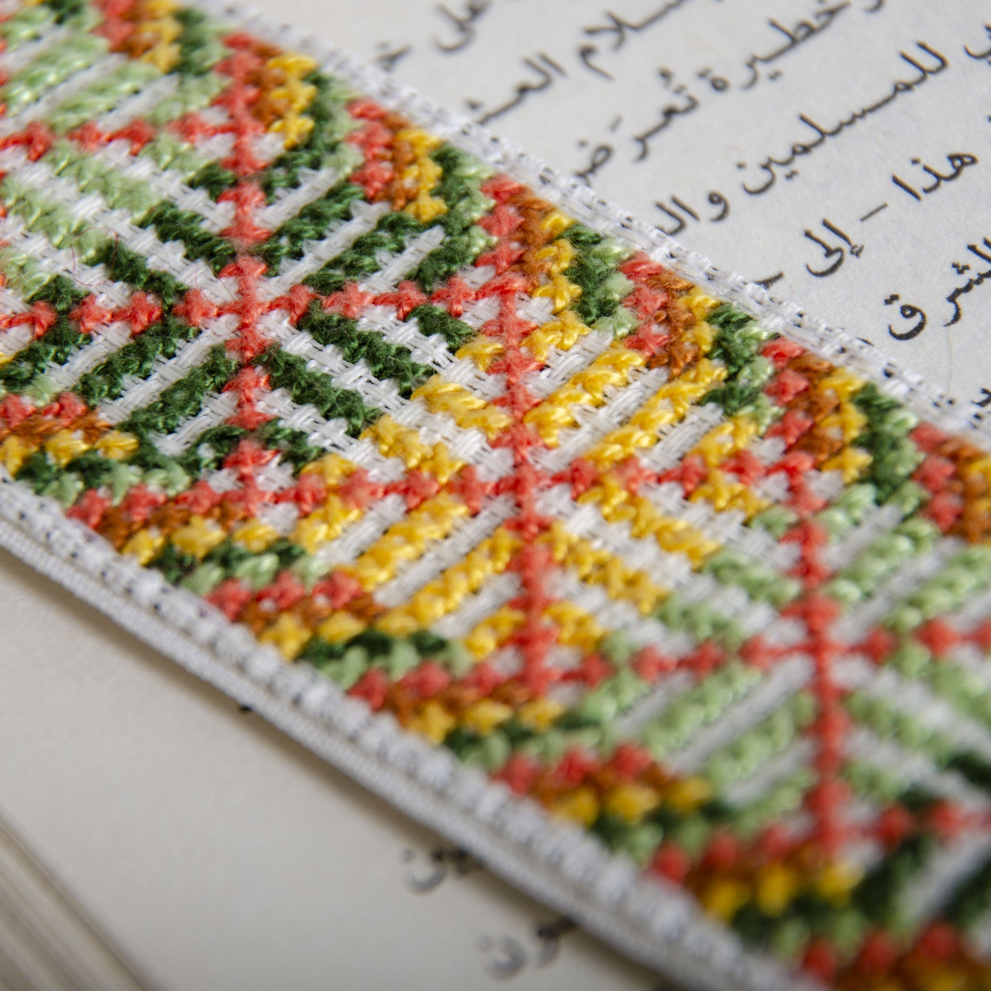 Palestinian tatreez embroidered bookmark placed inside an open book
