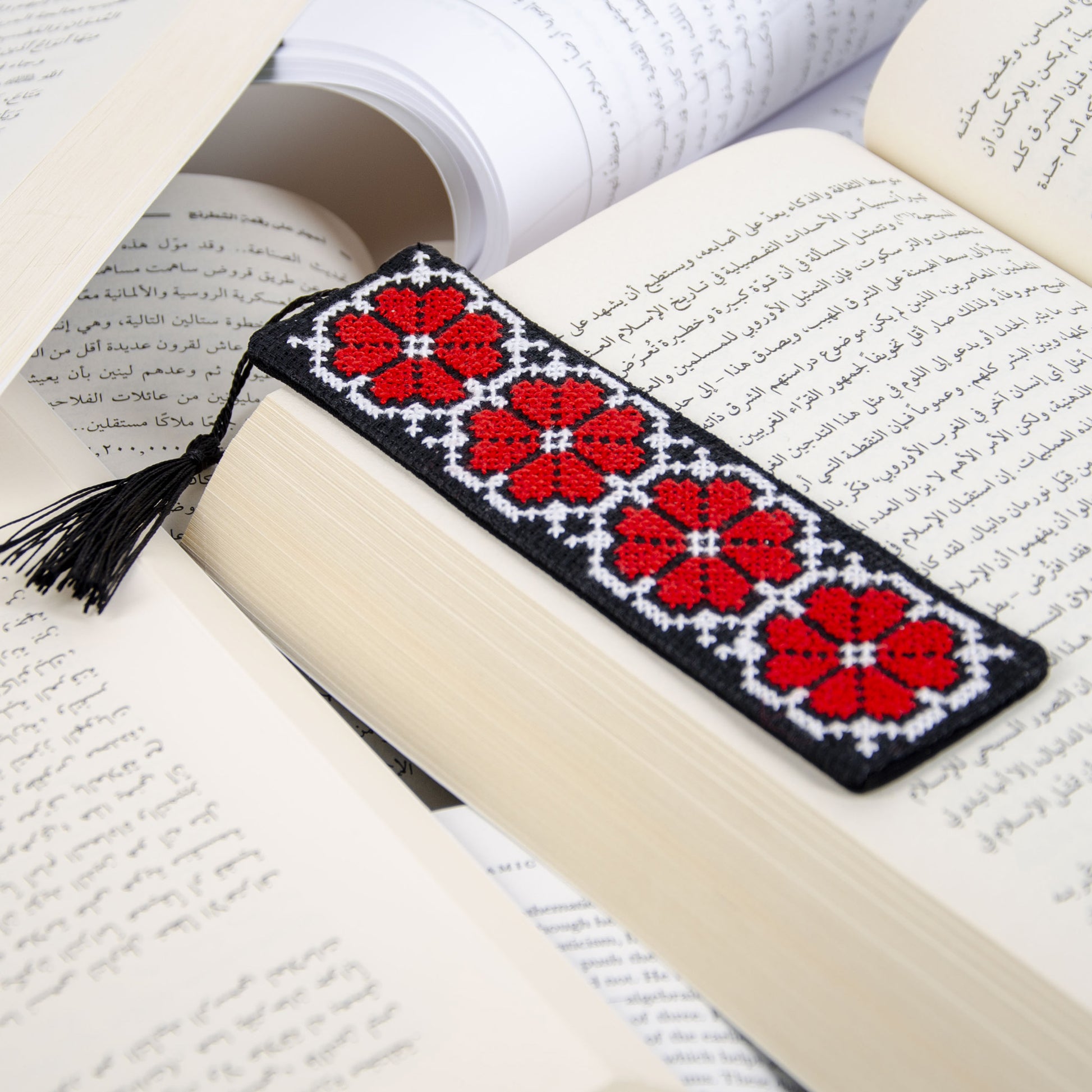 Handmade tatreez bookmark in reading setting showing textile embroidery
