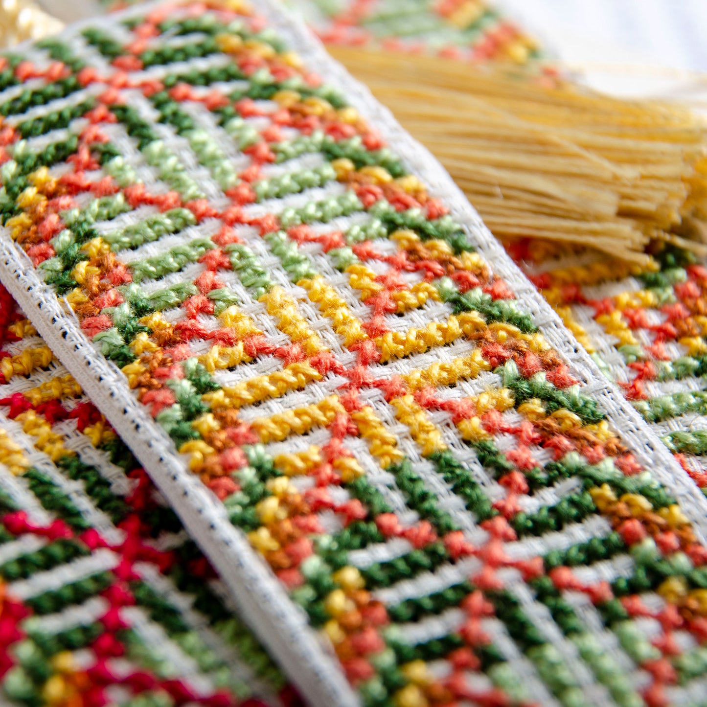 Close-up detail of Palestinian tatreez stitching on handmade bookmark